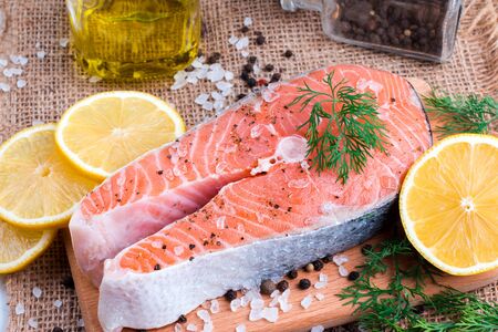 Raw salmon fish steak on wooden backgroundの写真素材