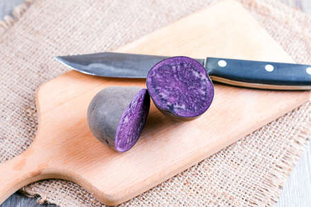 Purple sweet potato on wooden backgroundの写真素材