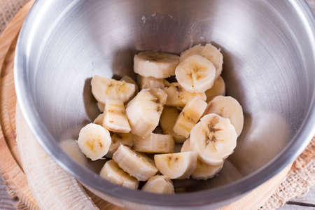 Sliced banana in a metal bowlの写真素材