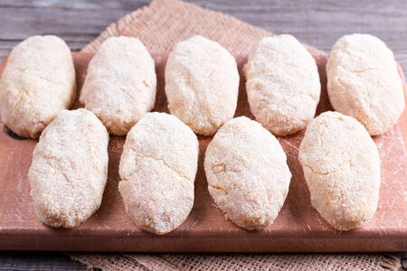 Raw cutlets on a cutting boardの写真素材