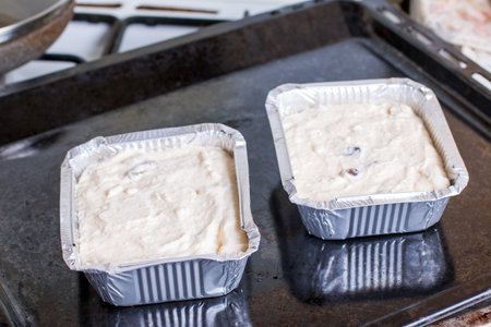 Cottage cheese casserole in foil tray on a baking sheetの写真素材