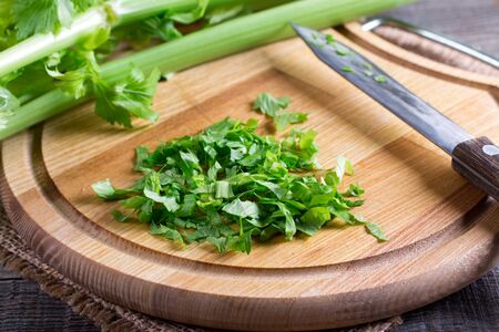 Chopped celery greens on a cutting boardの写真素材