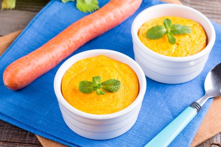 Souffle with carrots and apples in ceramic ramekin on wooden table. Delicious and healthy Breakfast for the whole familyの写真素材
