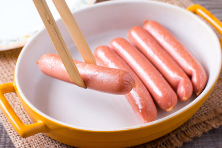 Barbecue sausages in the form for baking on wooden table, close upの写真素材