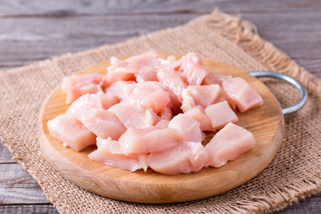 Raw chicken meat on cutting board on a wooden table. Selective focusonの写真素材