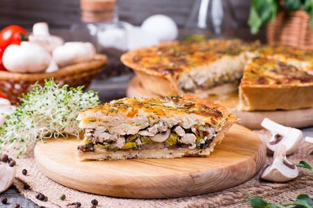 Traditional french quiche pie with chicken and mushroom on the tableの写真素材