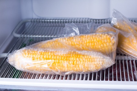 Frozen corn in bag in freezer close up. Frozen foodの写真素材