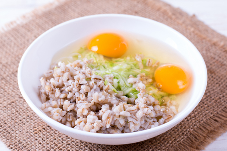 Grated zucchini with egg and porridge, food close upの写真素材