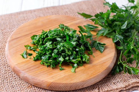 Cutting board with green chopped herbs. Parsleyの写真素材