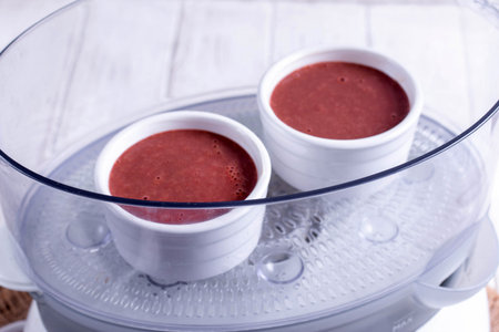 Liver souffle in a double boiler on the table. Cooking