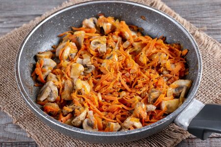 Fried onion and carrot with frying panの写真素材