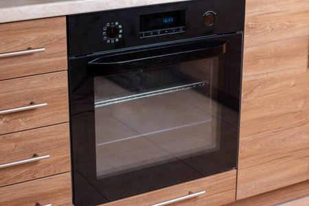 Electric oven in the kitchen. Kitchen cabinets and built-in electric oven