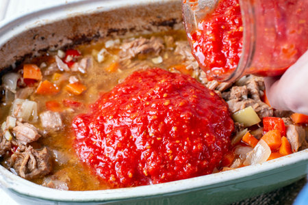A stew with spices in ceramic form. Cooking goulash