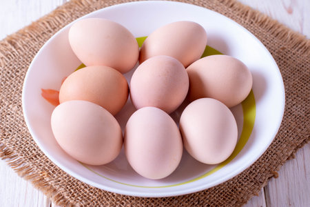 Boiled eggs with shell in a plate on the table. Easter