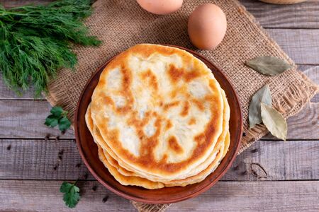 Khychiny - traditional caucasian flatbread filled with cheese and herbs. Flat breadの写真素材