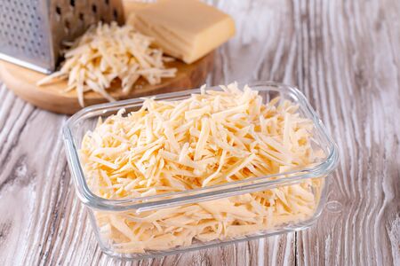 Grated cheese in a glass container. Frozen cheeseの写真素材