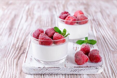 Cottage cheese dessert with frozen strawberries on the tableの写真素材