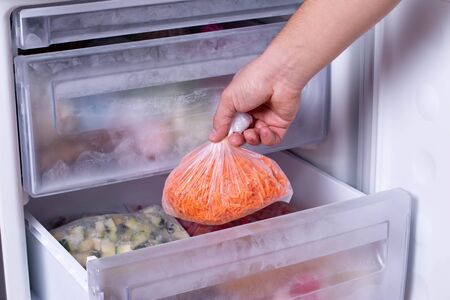 Frozen Carrot, frozen vegetables in bags in refrigeratorの写真素材