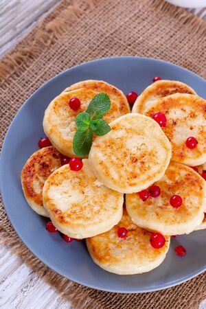 Cottage cheese pancakes with berries on a plate, breakfastの写真素材