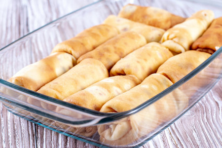 Pancakes with filling in a baking dish. Russian traditional dish. Pancakes with filling. Pancakes...