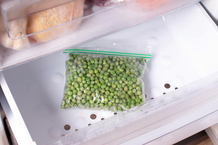 Frozen green pea in plastic bag with from refrigerator, closeup