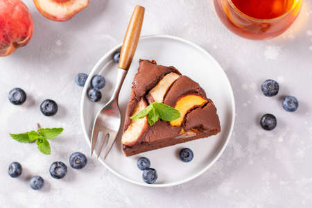 Delicious homemade peach pie with blueberries on a gray concrete background. Top viewの写真素材
