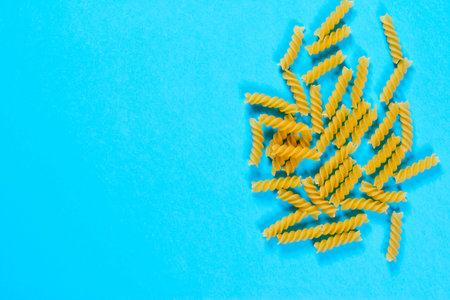 Italian pasta on a blue background. Top view. Flat lay Colorful and stylish composition.