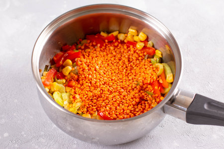 Cooking vegetable stew with lentils in a saucepan. Healthy food concept. Vegetarian food concept
