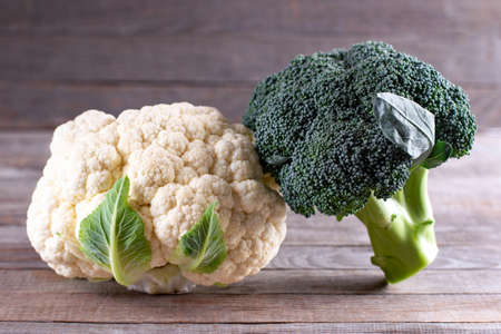 Fresh Organic cauliflower and broccoli on wooden table. Fresh vegetables. Healthy diet.の写真素材