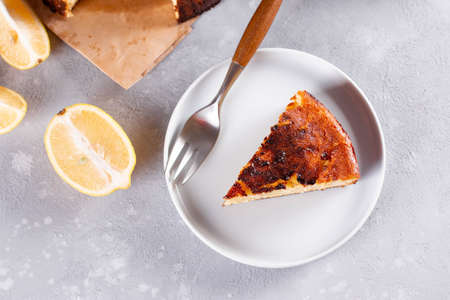 Piece of San Sebastian Basque Cheesecake on the plate on a light background. Top view, copy spaceの写真素材