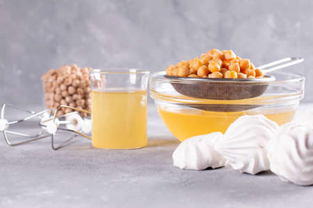 Chickpea broth aquafaba, liquid water brine, Replace egg in baking for vegan recipe. Vegan diet drink, marble background copy spaceの写真素材