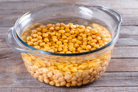 Chickpea in pan with water, cooking process. Healthy diet conceptの写真素材