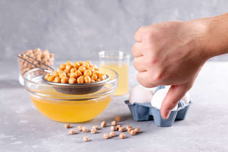 Aquafaba, chickpea water brine draining. Replace egg for vegan recipeの写真素材