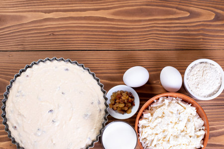 Dairy product for making casseroles at wooden table. Curd, milk, cheese and eggs. Organic farmer food. Top view with copy space.の写真素材