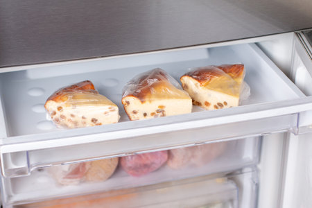 Frozen cheesecake with raisins in the freezer. Frozen cottage cheese casserole, frozen foodの写真素材