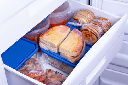 Frozen food in the freezer. Food storage. Concept of storing ready made dinner and saving time.の写真素材