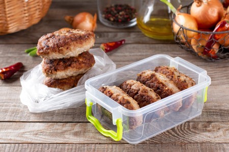 Frozen cutlets in a container. Ready frozen food. Fast cooking concept. Semi finished frozen cutletsの写真素材