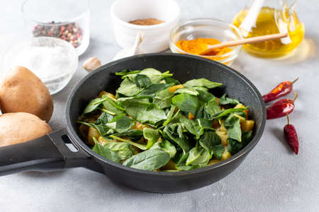 Aloo Palak sabzi. Spinach Potatoes curry served in a bowl. Ingredients. Step by step cooking. Popular Indian healthy recipeの写真素材