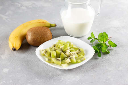 Ingredients for making chocolate chia pudding with banana and kiwi on gray table. Healthy vegan breakfastの写真素材