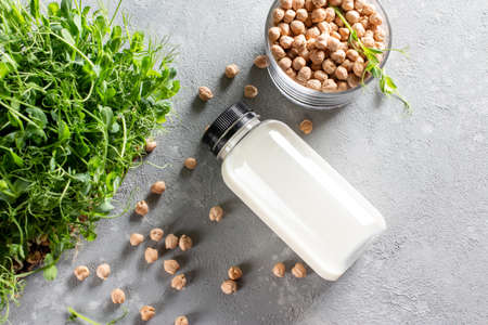 Alternative vegan milk of chickpeas in bottle on light gray background. Non-dairy lactose free milk. Top viewの写真素材