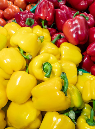 Red and yellow peppers in a box on a store counter. Vegetable department in a supermarket.の写真素材