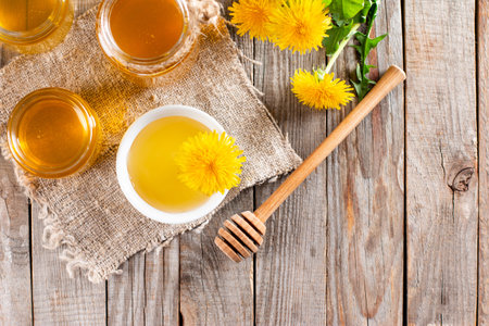 Homemade dandelion honey or syrup in glass jar. Concept of natural, countryside, organic and healthy product. Top view. Copy spaceの写真素材