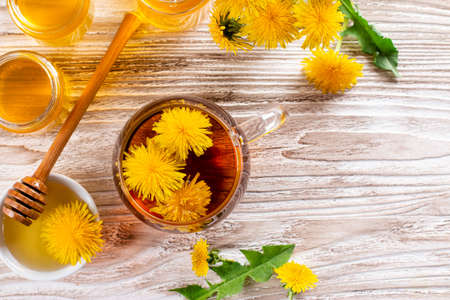 Honey from dandelion and a Cup of tea. Concept of natural, countryside, organic and healthy product. Top view. Copy spaceの写真素材