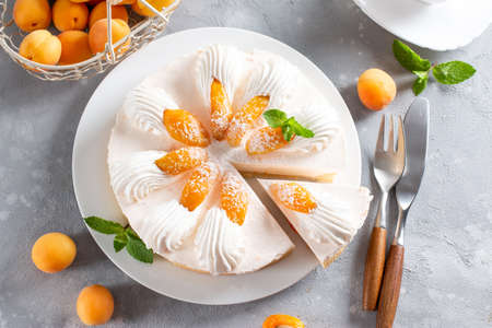 Fresh apricot cheesecake on light background. Top view. Healthy summer dessert concept. Selective focus.の写真素材