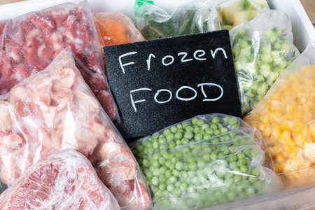 Plastic bags with different frozen vegetables in refrigerator. Frozen Food. Food storageの写真素材