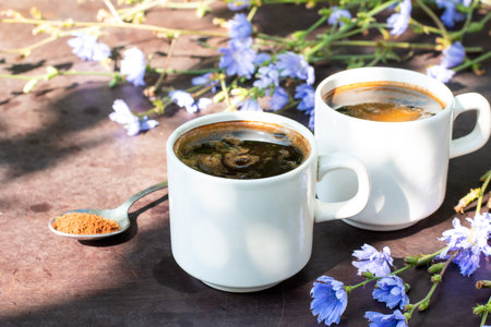 Healthy chicory drink in cup decorated chicory flowers. Herbal beverage, coffee substitute. Selective focusの写真素材