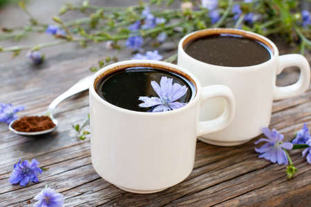 Healing drinks, chicory drink, cup of chicory drink and flowers on a table. Selective focusの写真素材