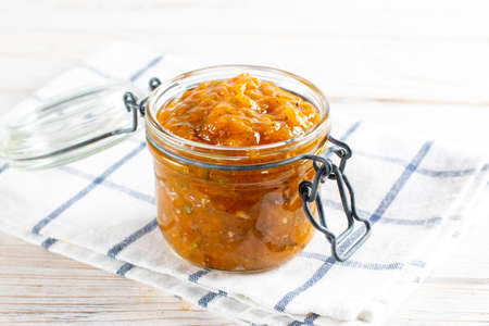 Spicy sauce from yellow plums, garlic, hot pepper, cilantro, dill and mint, known as tkemali. Georgian cuisine. Preserving, harvesting.の写真素材