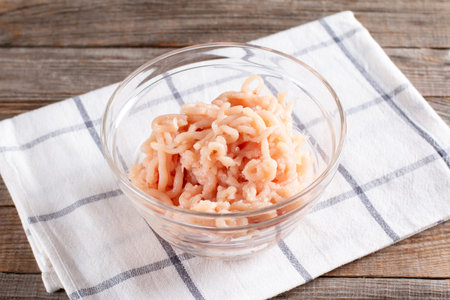 Chicken mince in a glass bowl. Preparation of the recipe, step by step. Homemade food
