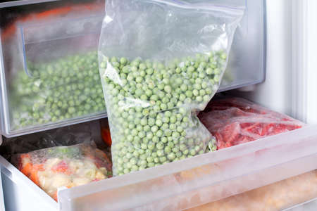Frozen green peas in the freezer. frozen foodの写真素材